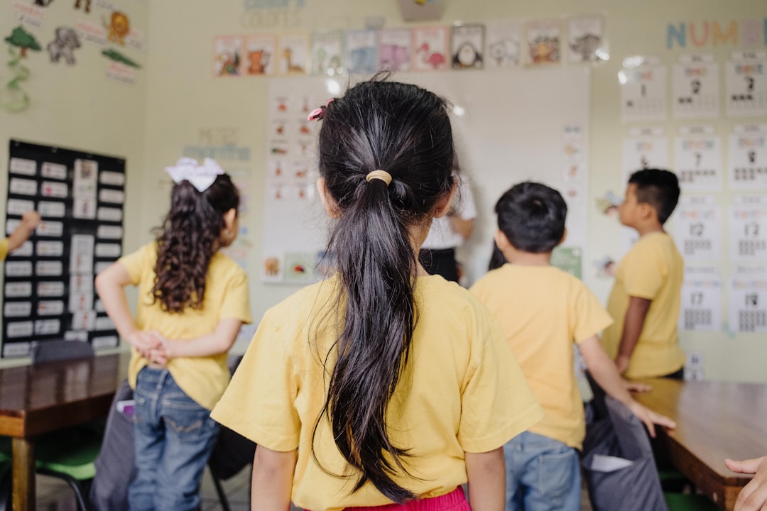 A group of children standing in a classroom